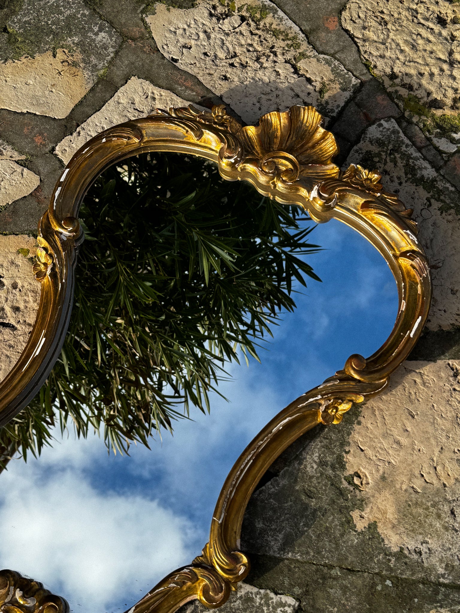 Velké starožitné zrcadlo ve zdobené rámu zlaté barvy